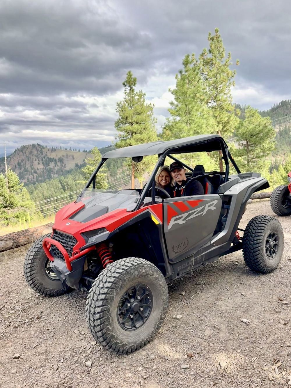 Red Polaris side-by-side on a mountain trail